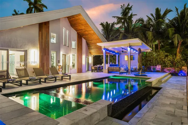 a view of swimming pool with outdoor seating