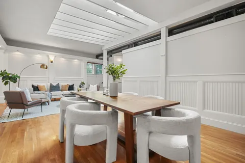 a kitchen with a table chairs and entryway