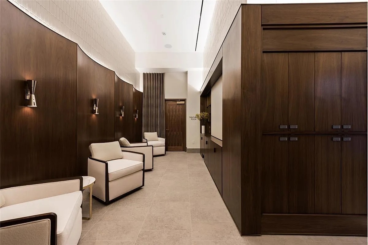 301 East 50th Street, Unit 4B Manhattan, NY 10022 - Photo 12 of 13 a hallway with couches and white walls with wooden floor