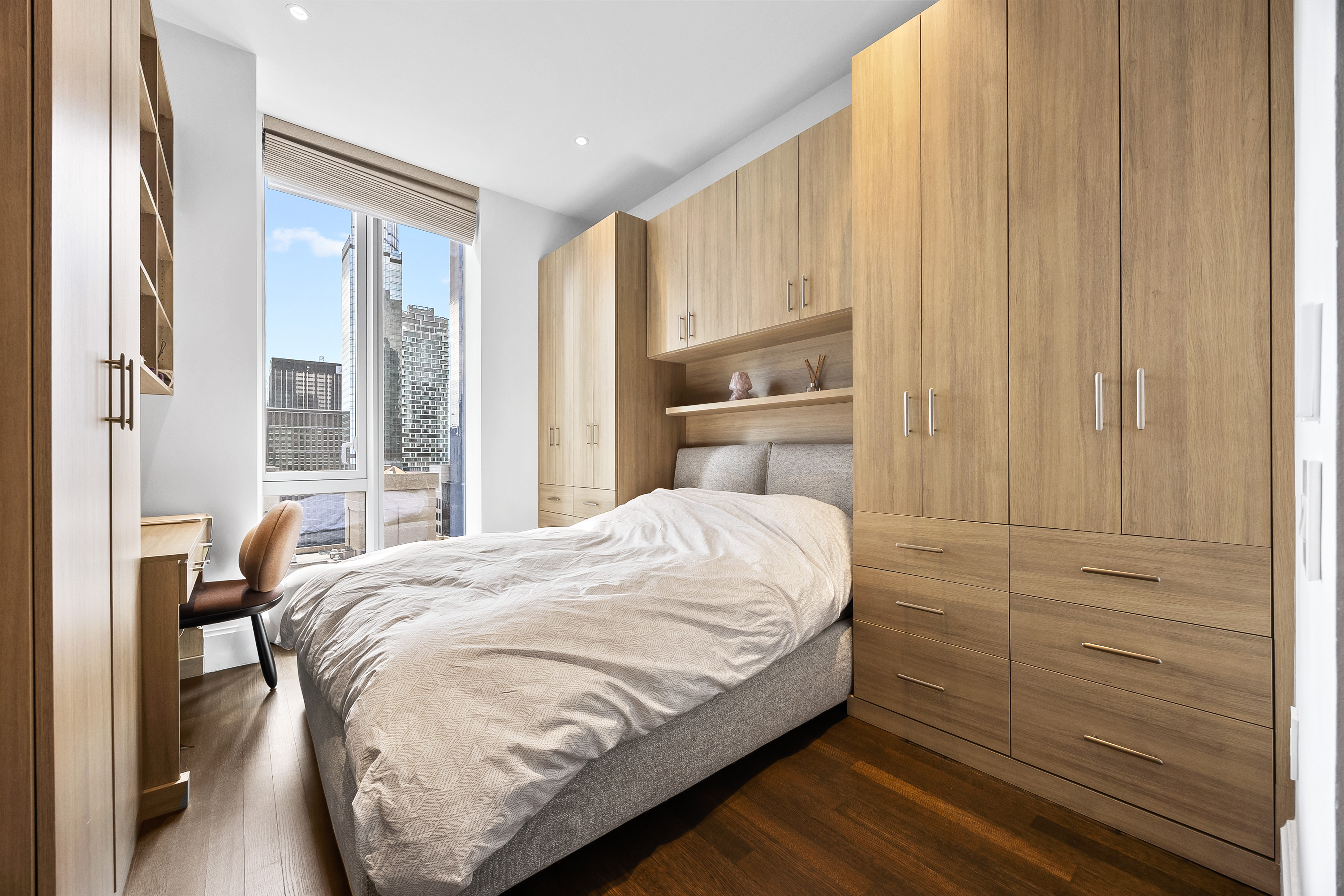 217 West 57th Street, Unit 36D Manhattan, NY 10019 - Photo 12 of 26 a bedroom with a bed and a window