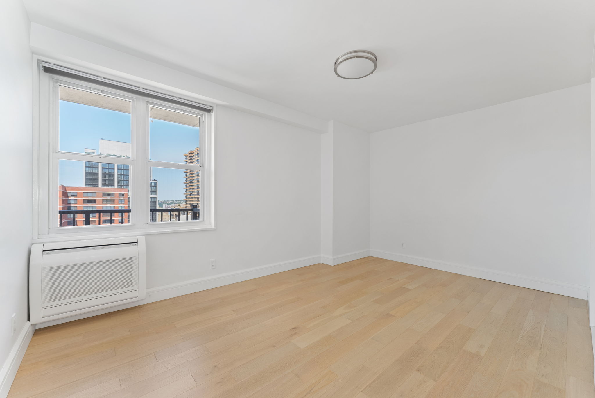 175 West 95th Street, Unit 15D Manhattan, NY 10025 - Photo 7 of 13 an empty room with windows