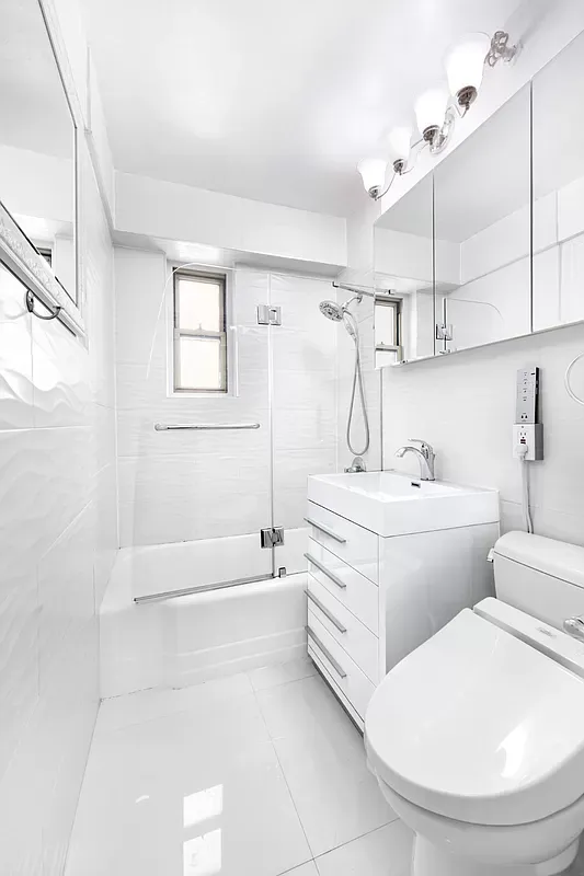 a bathroom with a sink a toilet and bathtub