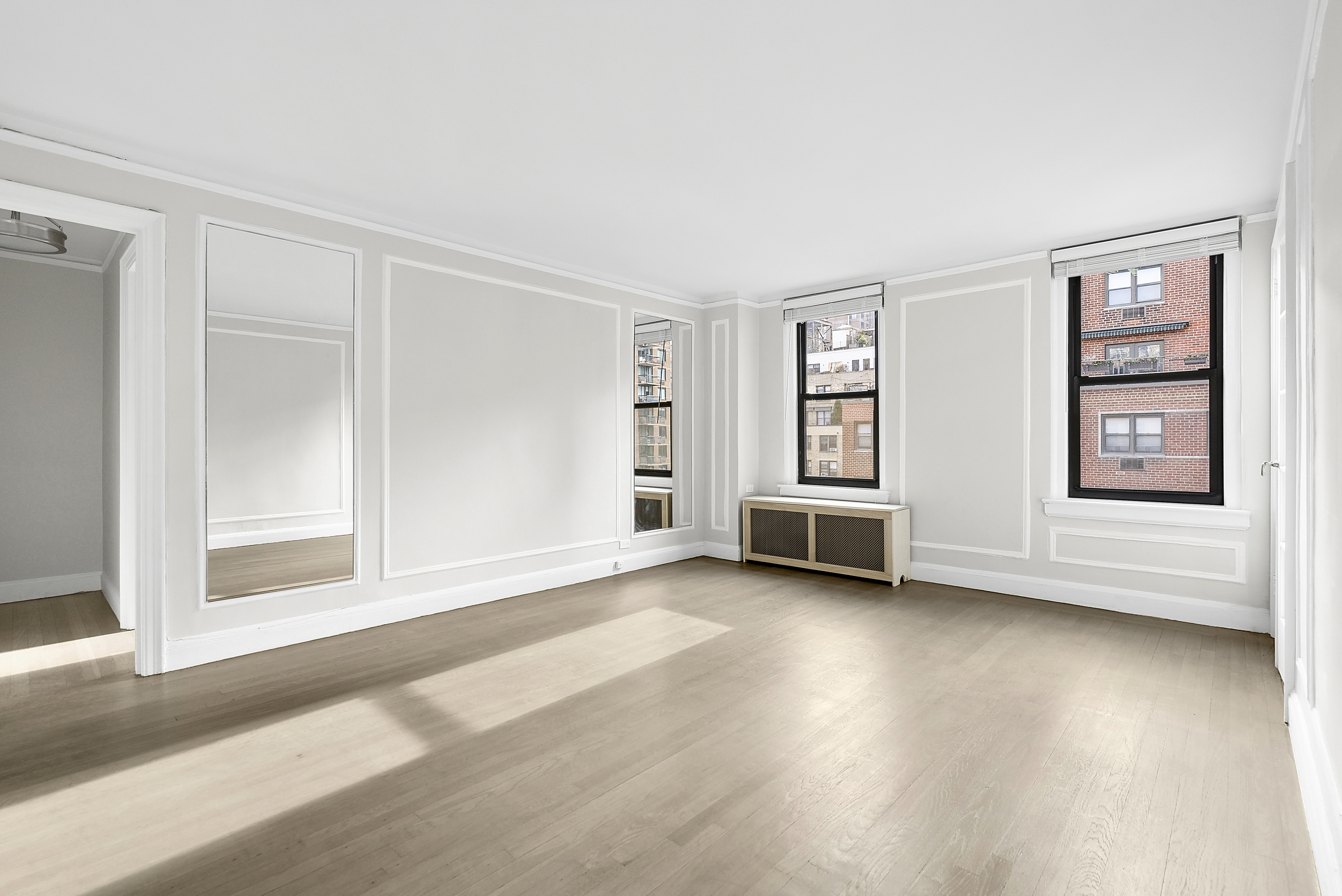 321 East 54th Street, Unit 10B Manhattan, NY 10022 - Photo 4 of 13 a view of an empty room with a window and wooden floor