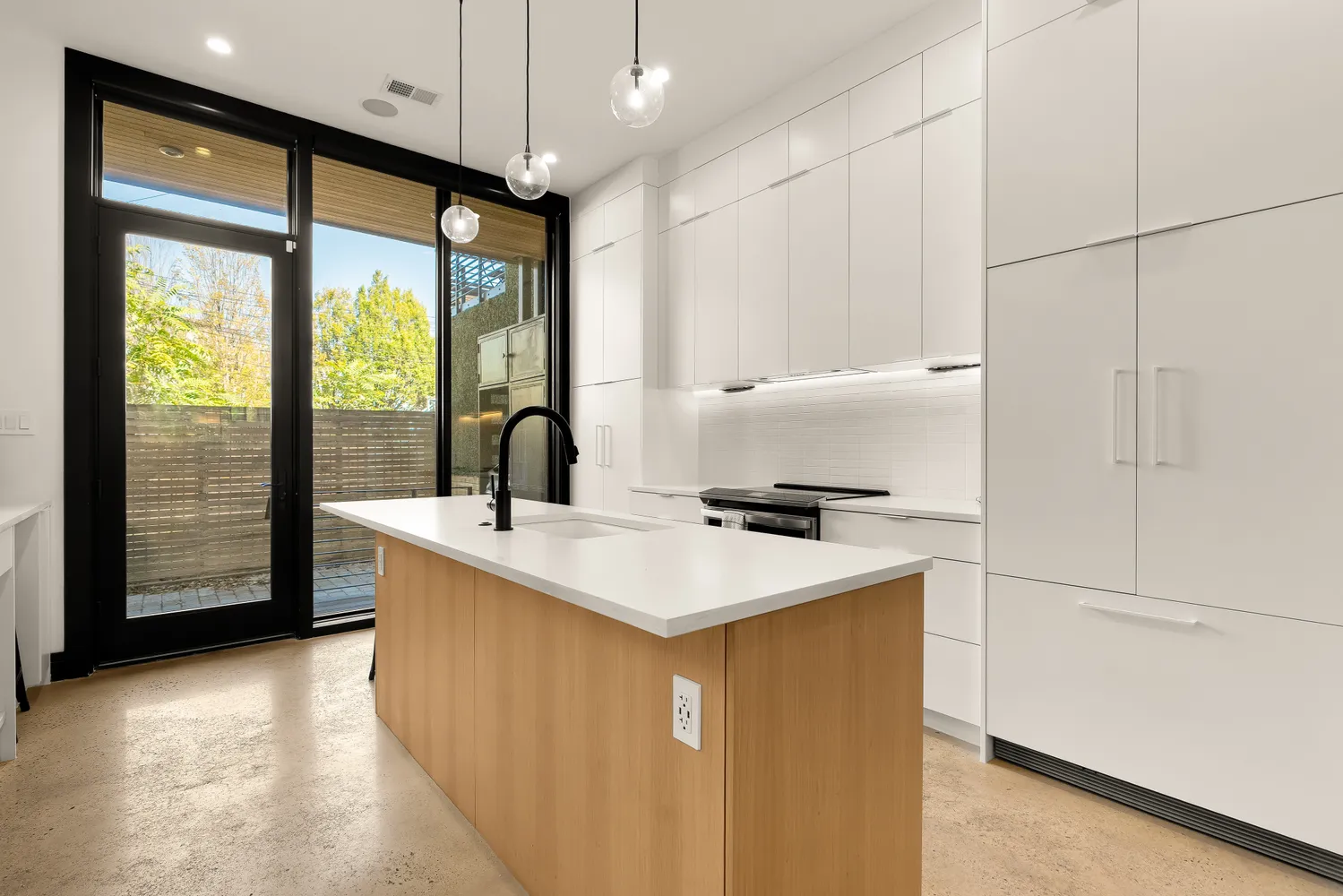 a kitchen with a sink a stove and cabinets