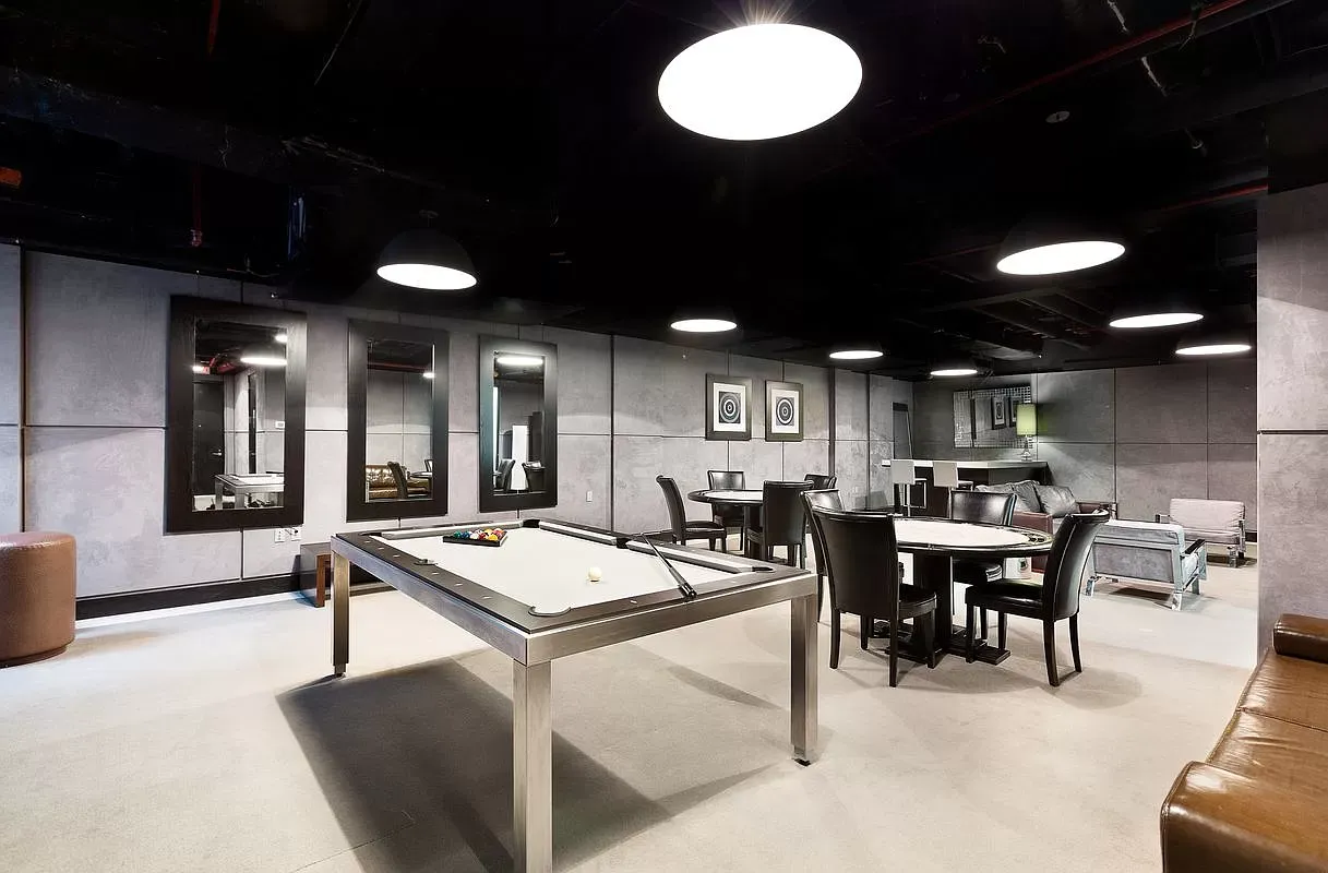 a dinning area with furniture and a chandelier