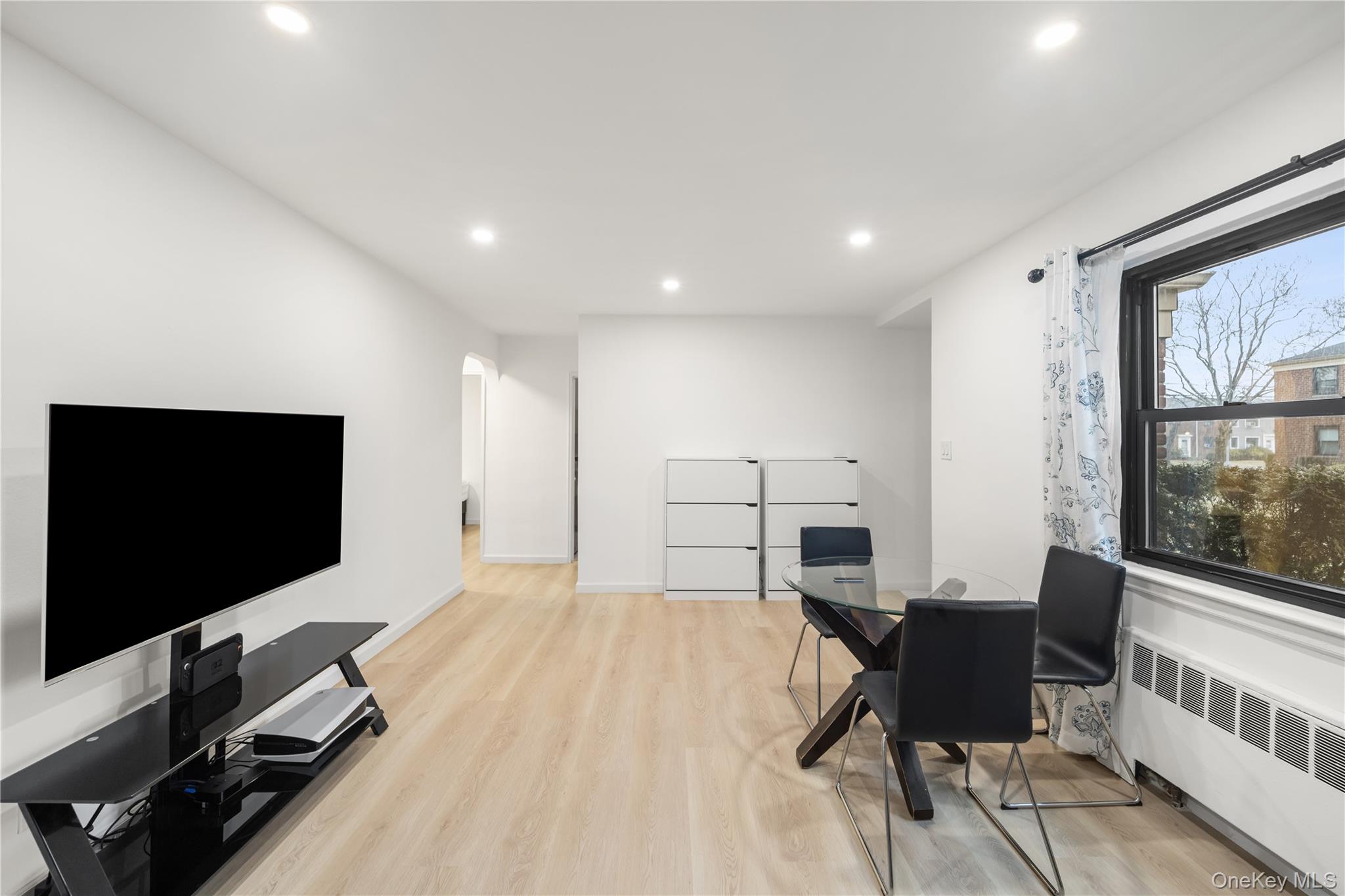 217-14 73rd Avenue, Unit 1 Queens, NY 11364 - Photo 8 of 19 a living room with furniture and a flat screen tv