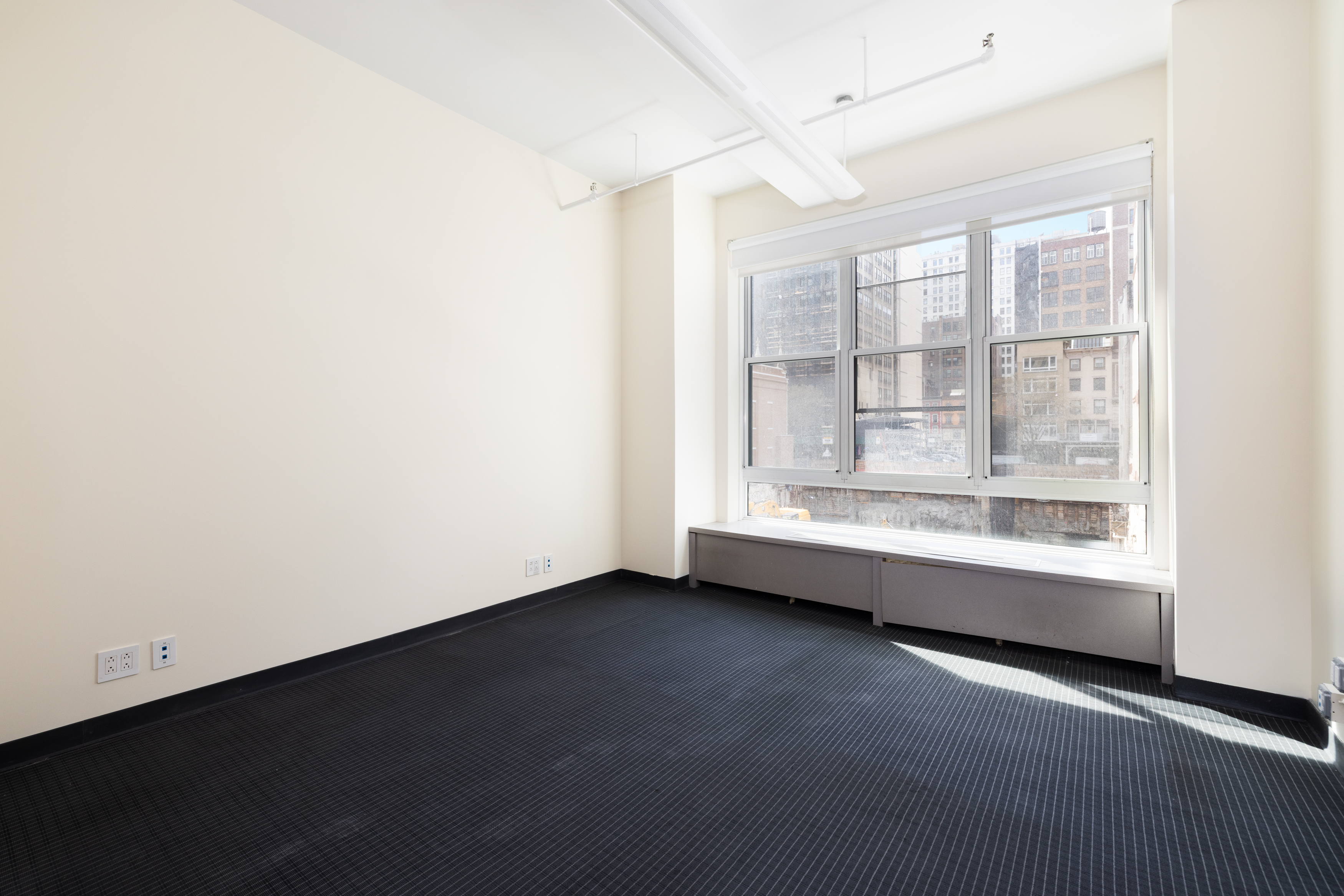11 West 30th Street, Unit 2F Manhattan, NY 10001 - Photo 8 of 12 an empty room with wooden floor and windows