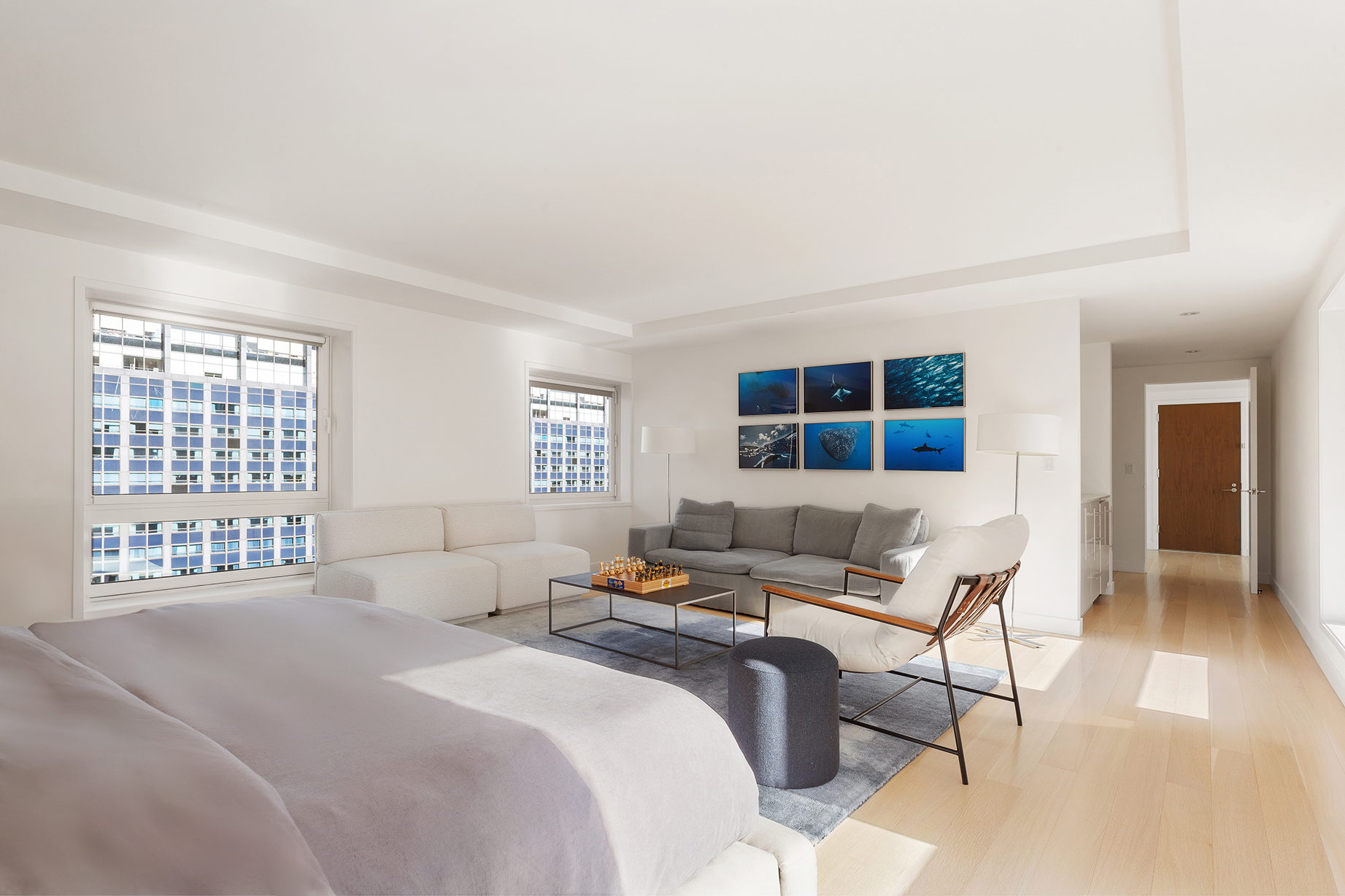 135 West 52nd Street, Unit PH3 Manhattan, NY 10019 - Photo 9 of 17 a bedroom with a bed and wooden floor