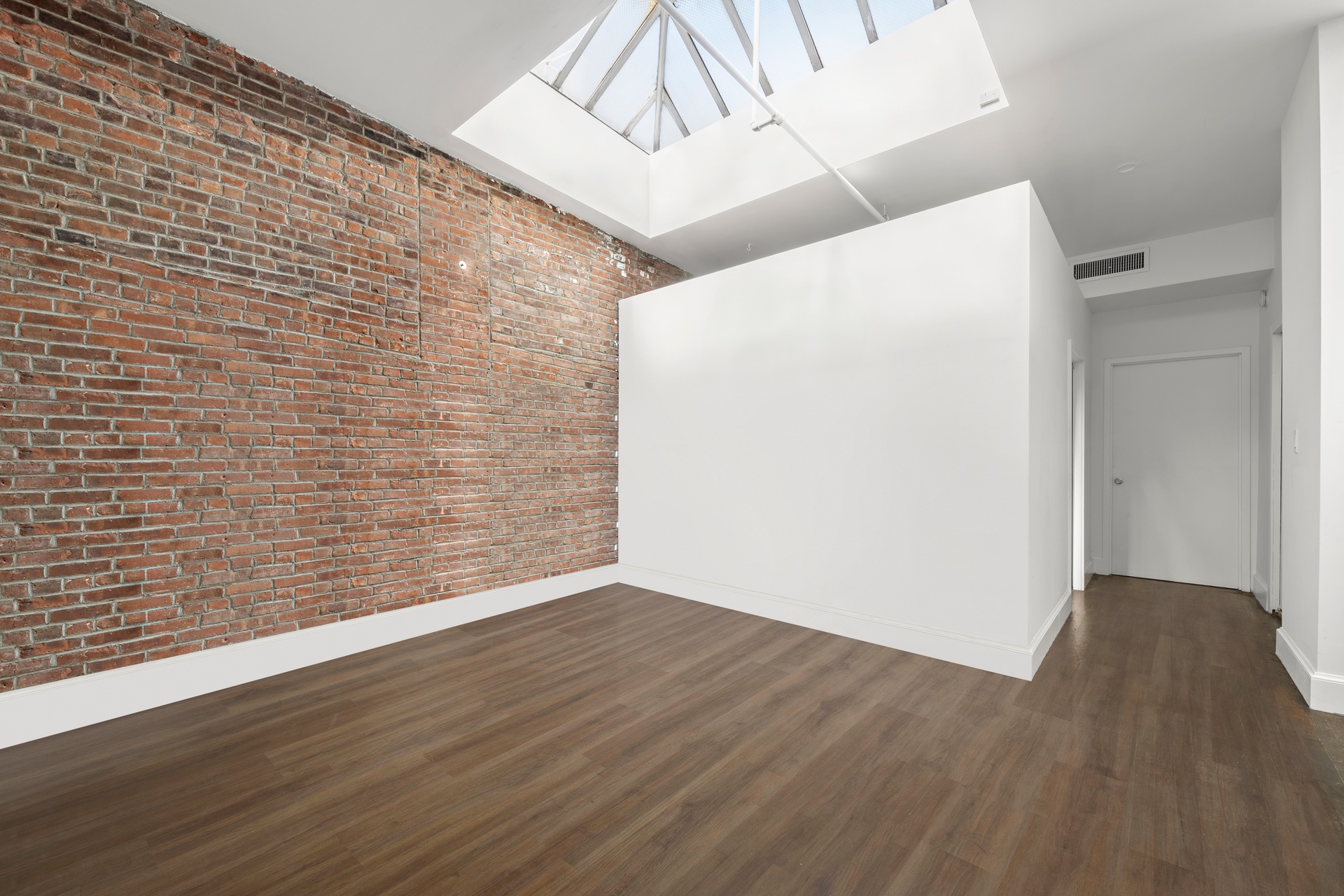 99 Spring Street, Unit PH6 Manhattan, NY 10012 - Photo 14 of 23 a view of an empty room with wooden floor