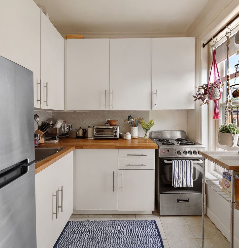 a kitchen with stainless steel appliances granite countertop a stove a sink and a white cabinets