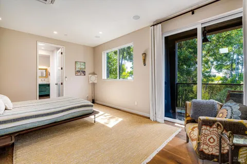 a spacious bedroom with a bed and a window