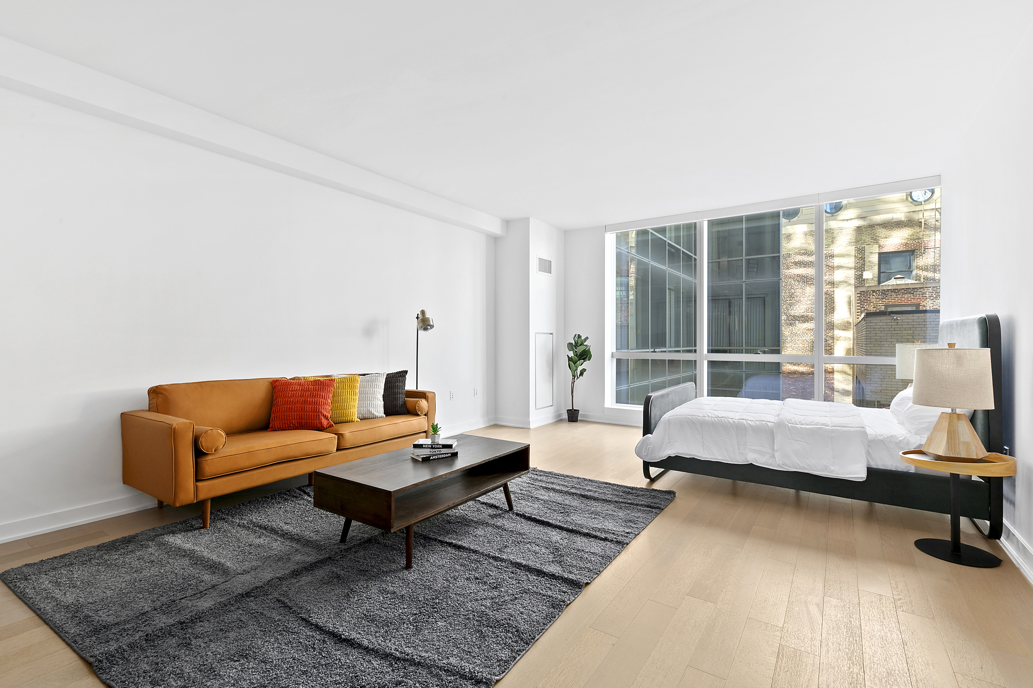 400 Park Avenue South, Unit 23G Manhattan, NY 10016 - Photo 1 of 7 a living room with furniture and a large window