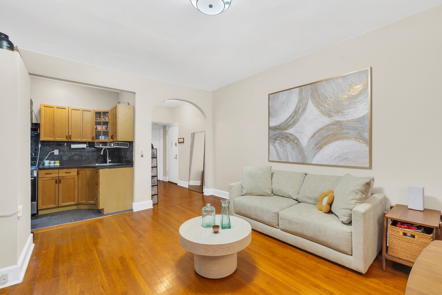 26 West 97th Street, Unit 2C Manhattan, NY 10025 - Photo 4 of 9 a living room with furniture and a wooden floor