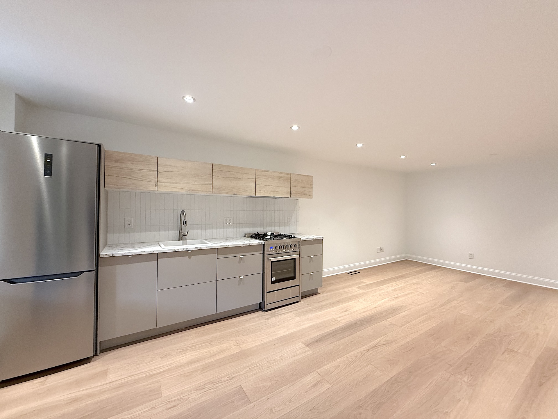 424 Pacific Street, Unit GARDEN Brooklyn, NY 11217 - Photo 4 of 16 a large kitchen with stainless steel appliances granite countertop a stove a sink and a refrigerator