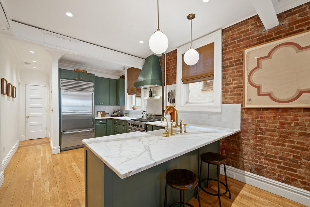 67 Perry Street, Unit 3 Manhattan, NY 10014 - Photo 11 of 22 a kitchen with a table and chairs in it