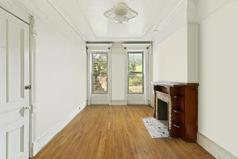 wooden floor in an empty room with a fireplace