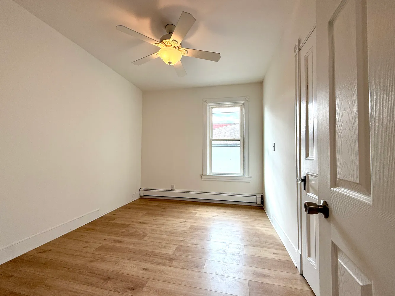 wooden floor in an empty room with a window