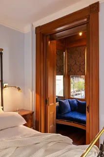 a bedroom with a bed and a window