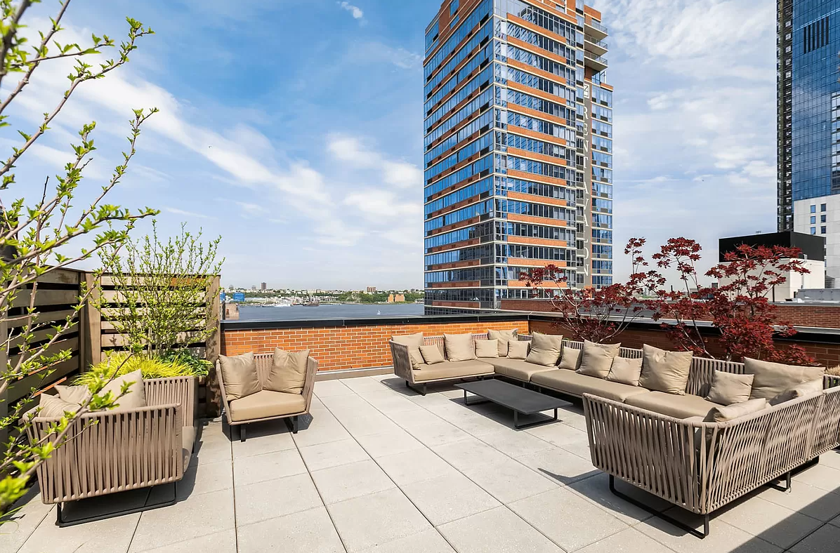540 West 28th Street, Unit 4F Manhattan, NY 10001 - Photo 12 of 16 a roof deck with couches and wooden floor
