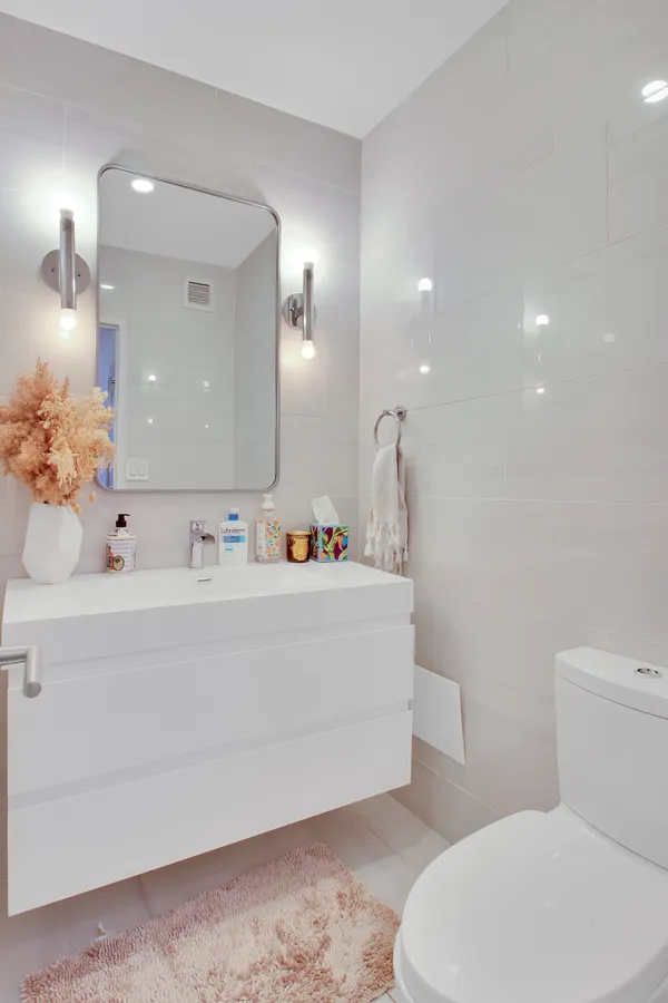 a bathroom with a sink a toilet and a mirror