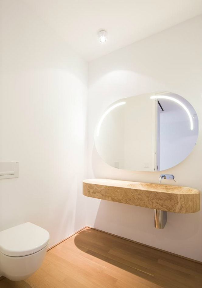 56 Leonard Street, Unit 12AEAST Manhattan, NY 10013 - Photo 5 of 11 a bathroom with a toilet sink and mirror