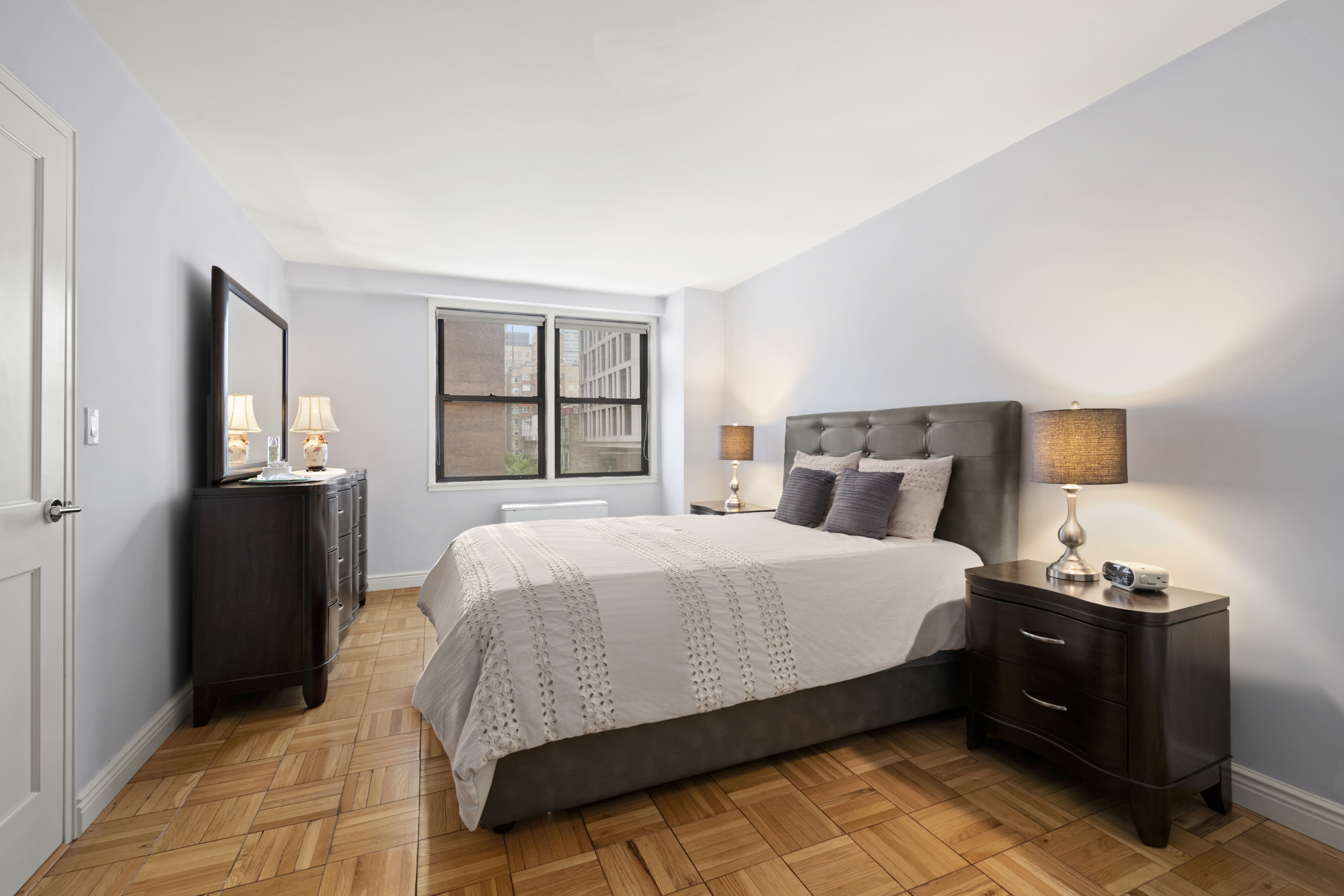 201 East 21st Street, Unit 7A Manhattan, NY 10010 - Photo 4 of 7 a bedroom with a bed and a window