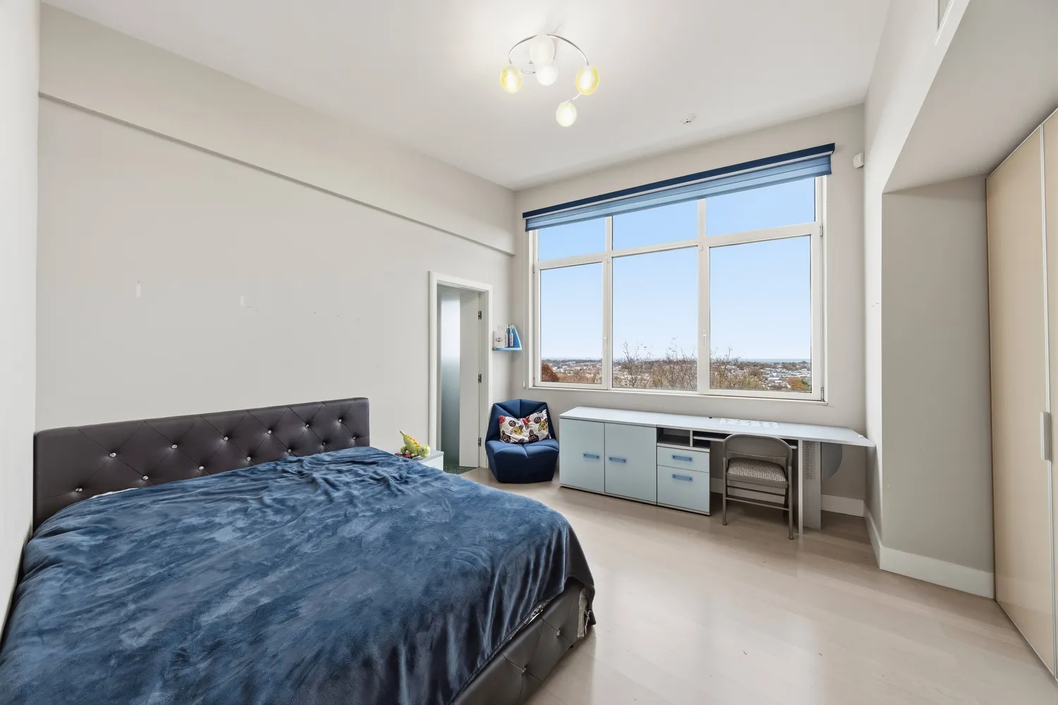 a bedroom with a bed and a desk