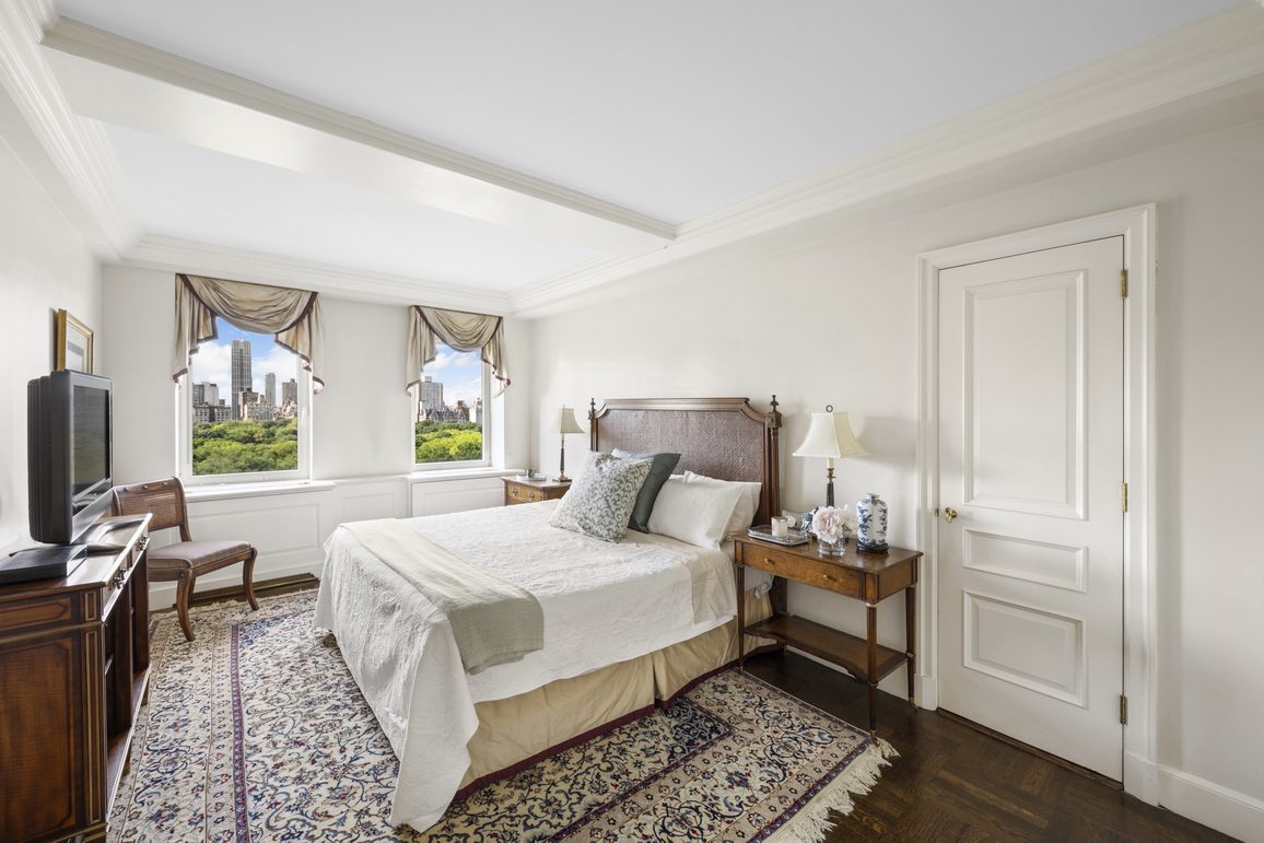 875 5th Avenue, Unit 18A Manhattan, NY 10065 - Photo 11 of 14 a bedroom with a bed wooden floor and window