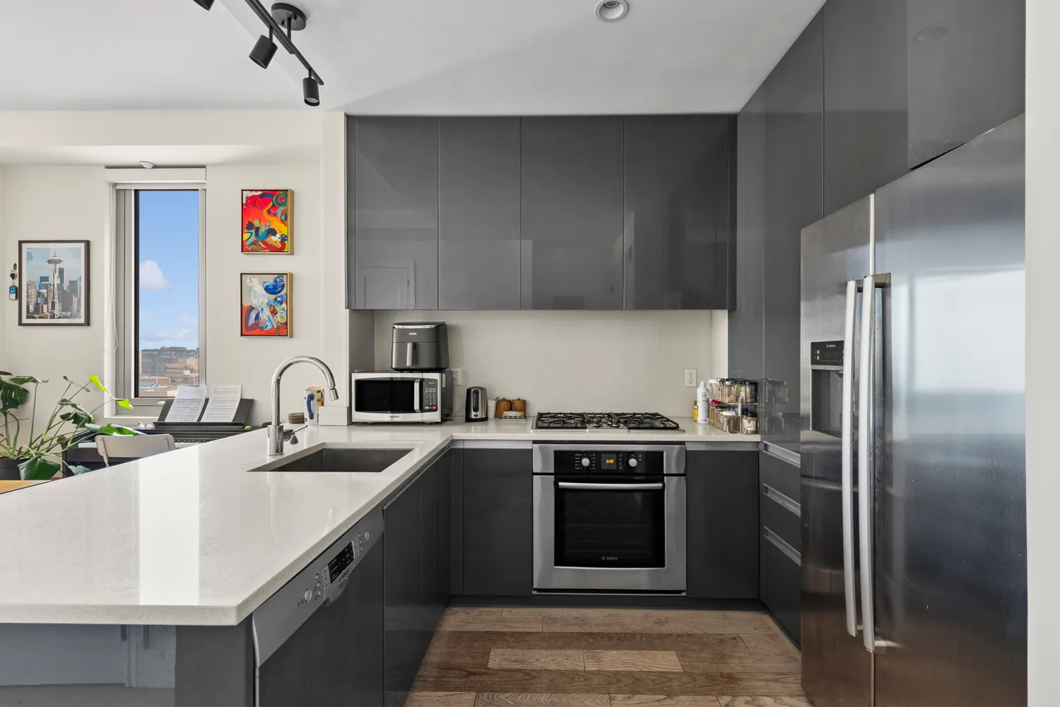 a kitchen with stainless steel appliances granite countertop a sink stove and refrigerator