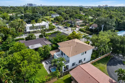an aerial view of multiple houses with a yard