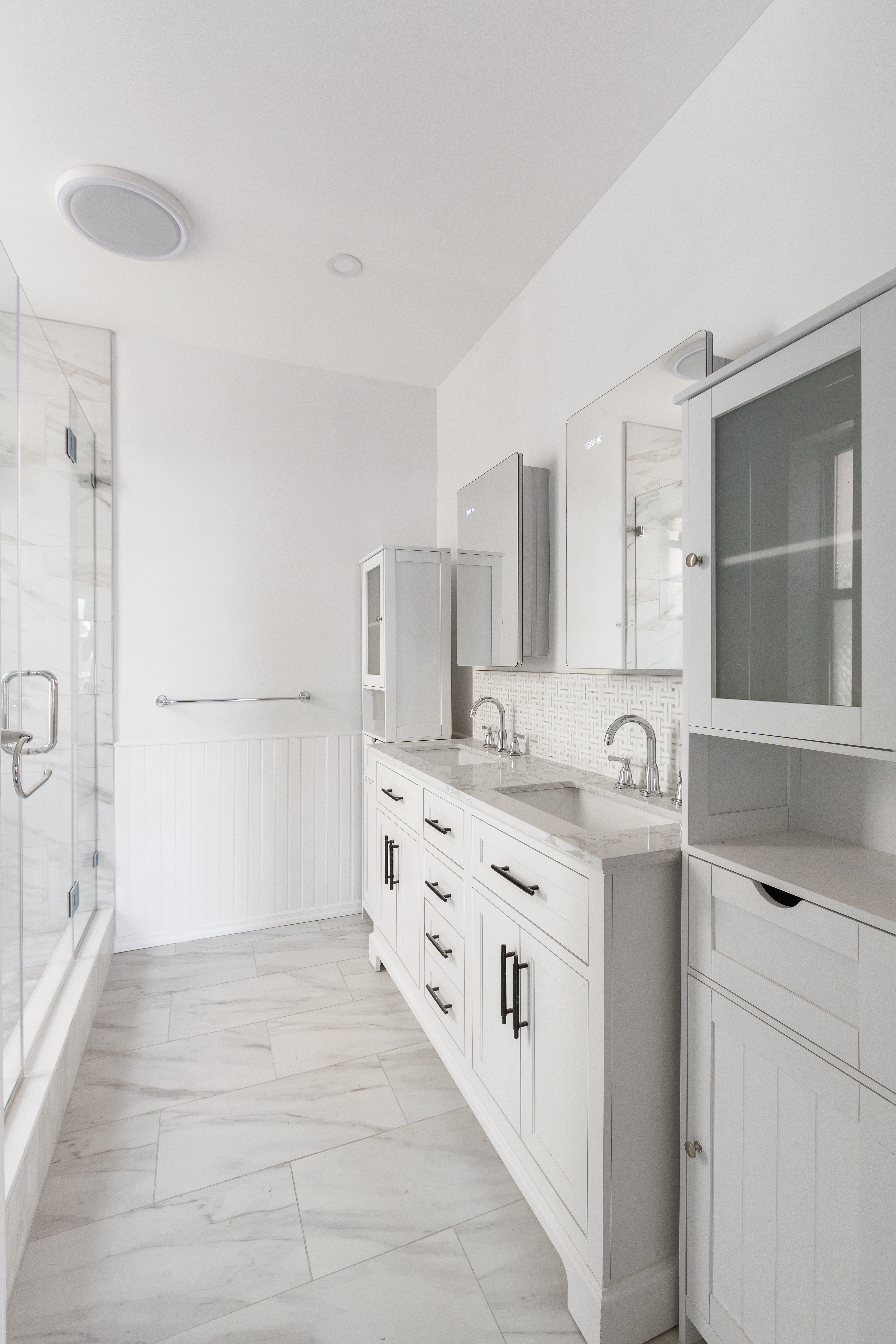 2773 Bedford Avenue Brooklyn, NY 11210 - Photo 12 of 17 a bathroom with a double vanity sink a mirror and a shower