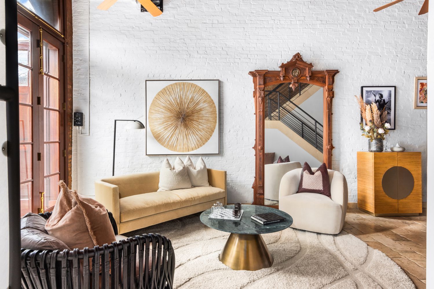 a living room with furniture and a painting on the wall