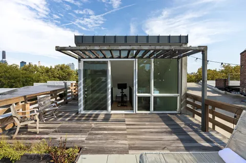 a front view of a house with a tree
