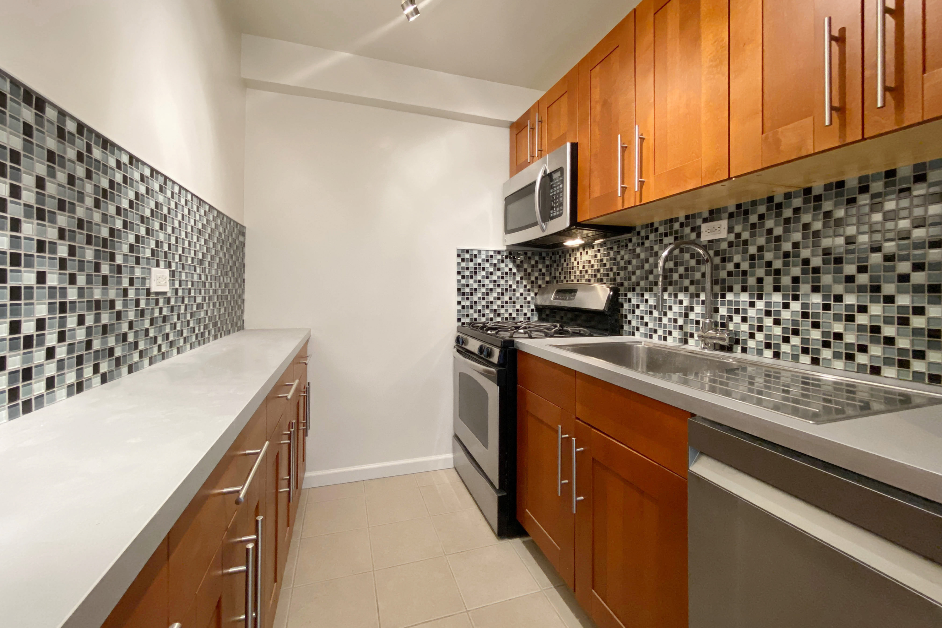 343 East 30th Street, Unit 16D Manhattan, NY 10016 - Photo 5 of 17 a kitchen with a sink and cabinets