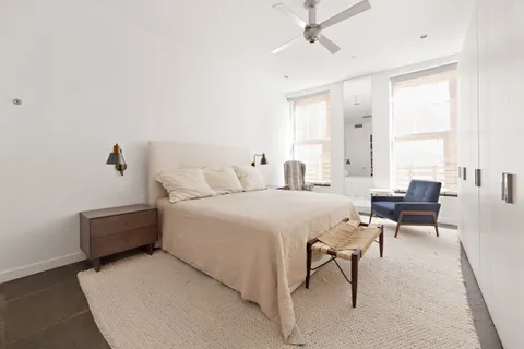 a bedroom with a bed and a couch