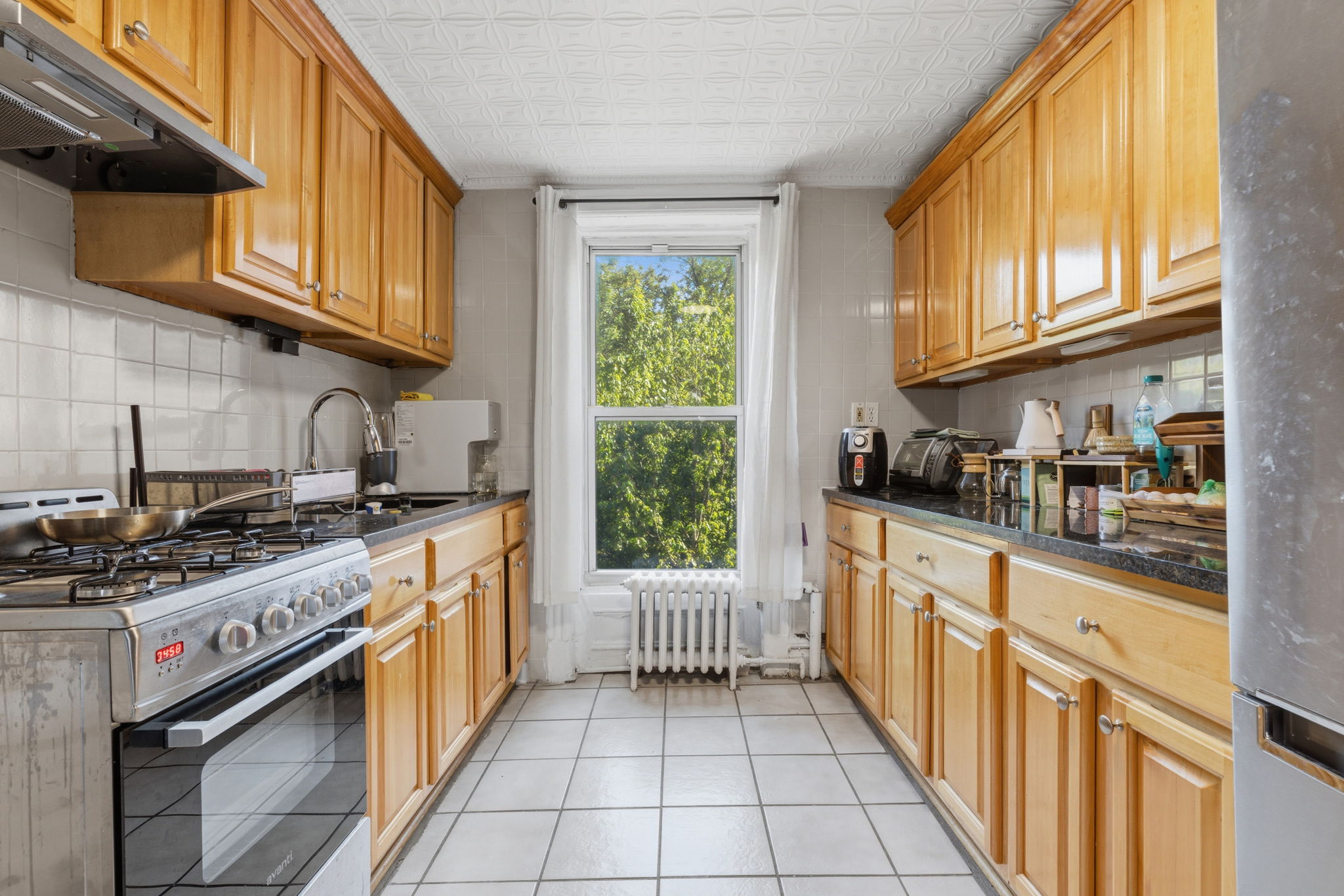 250 Saint Marks Avenue, Unit 3 Brooklyn, NY 11238 - Photo 2 of 8 a kitchen with stainless steel appliances granite countertop a stove and a sink