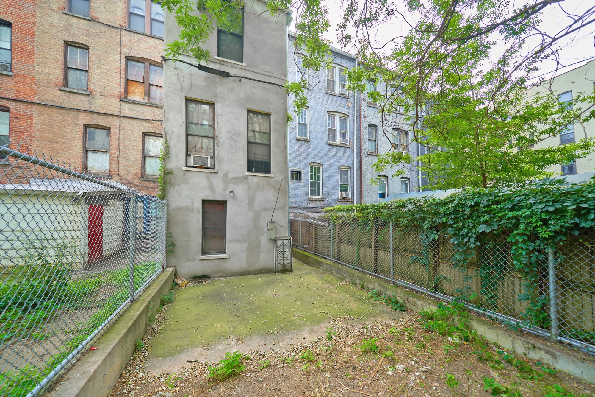 197 Edgecombe Avenue Manhattan, NY 10030 - Photo 11 of 12 front view of a brick house with a yard