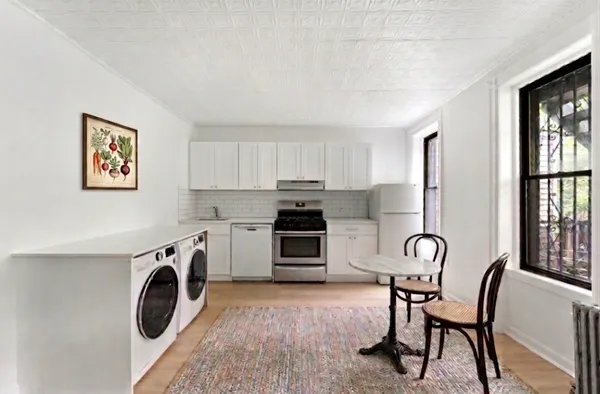 a kitchen with a stove top oven sink and a window