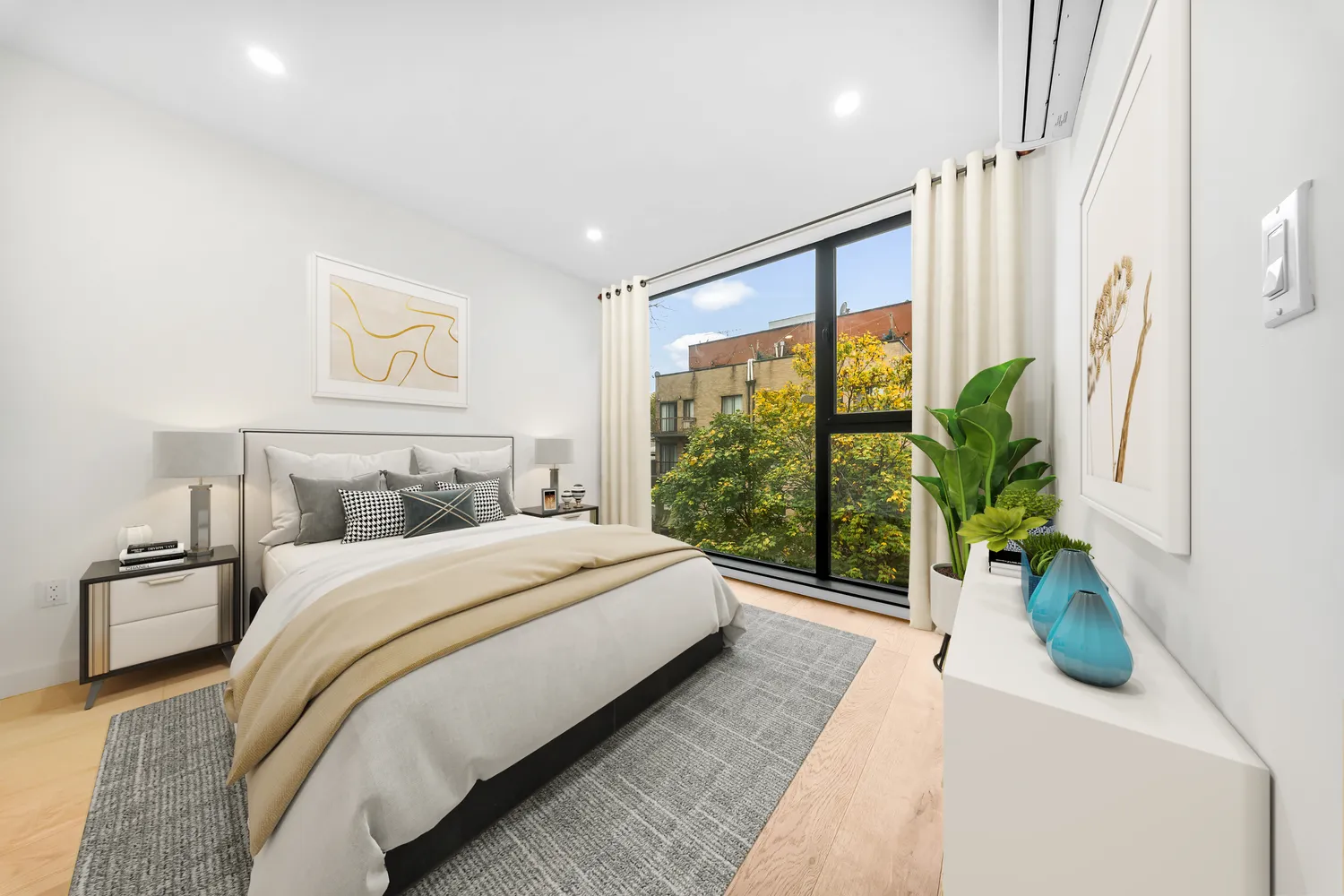 a bedroom with a bed and a large window