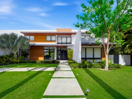 a front view of house with yard and green space