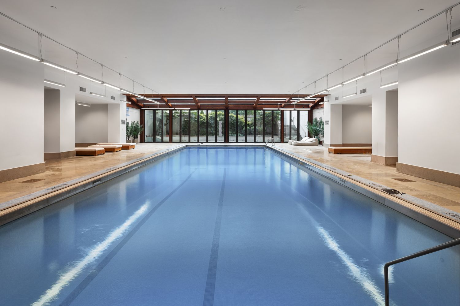 a large hall with kitchen island granite countertop a large counter space a sink appliances and cabinets