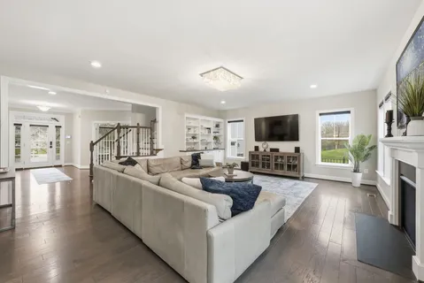 a living room with fireplace furniture and a flat screen tv