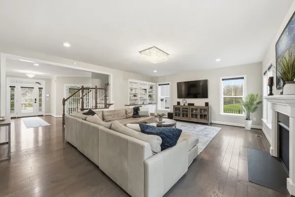 a living room with furniture a fireplace and a flat screen tv