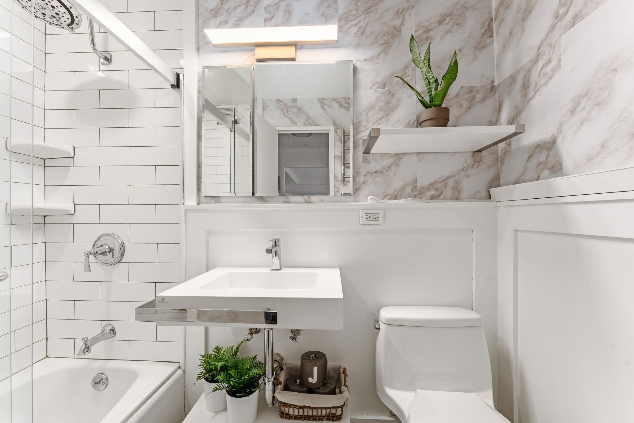 315 West 70th Street, Unit 5F Manhattan, NY 10023 - Photo 6 of 9 a bathroom with a sink a toilet and bathtub