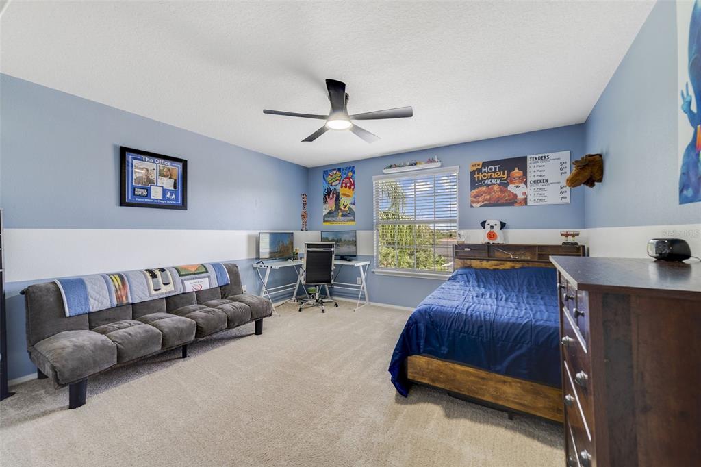 352 Giovani Boulevard Clermont, FL 34715 - Photo 27 of 46 a living room with furniture and a flat screen tv