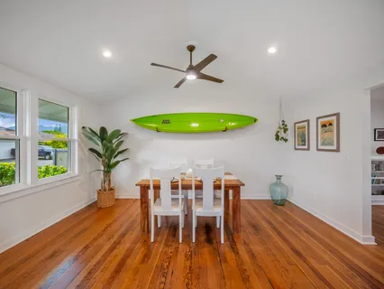 a living room with furniture a potted plant and a large window