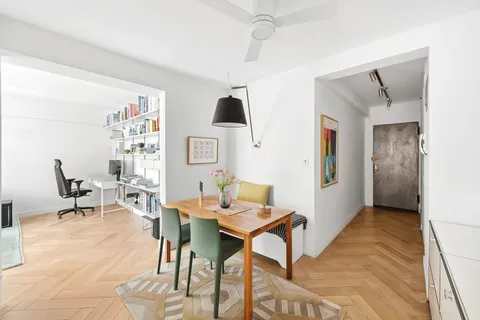 a view of a livingroom with furniture and a window