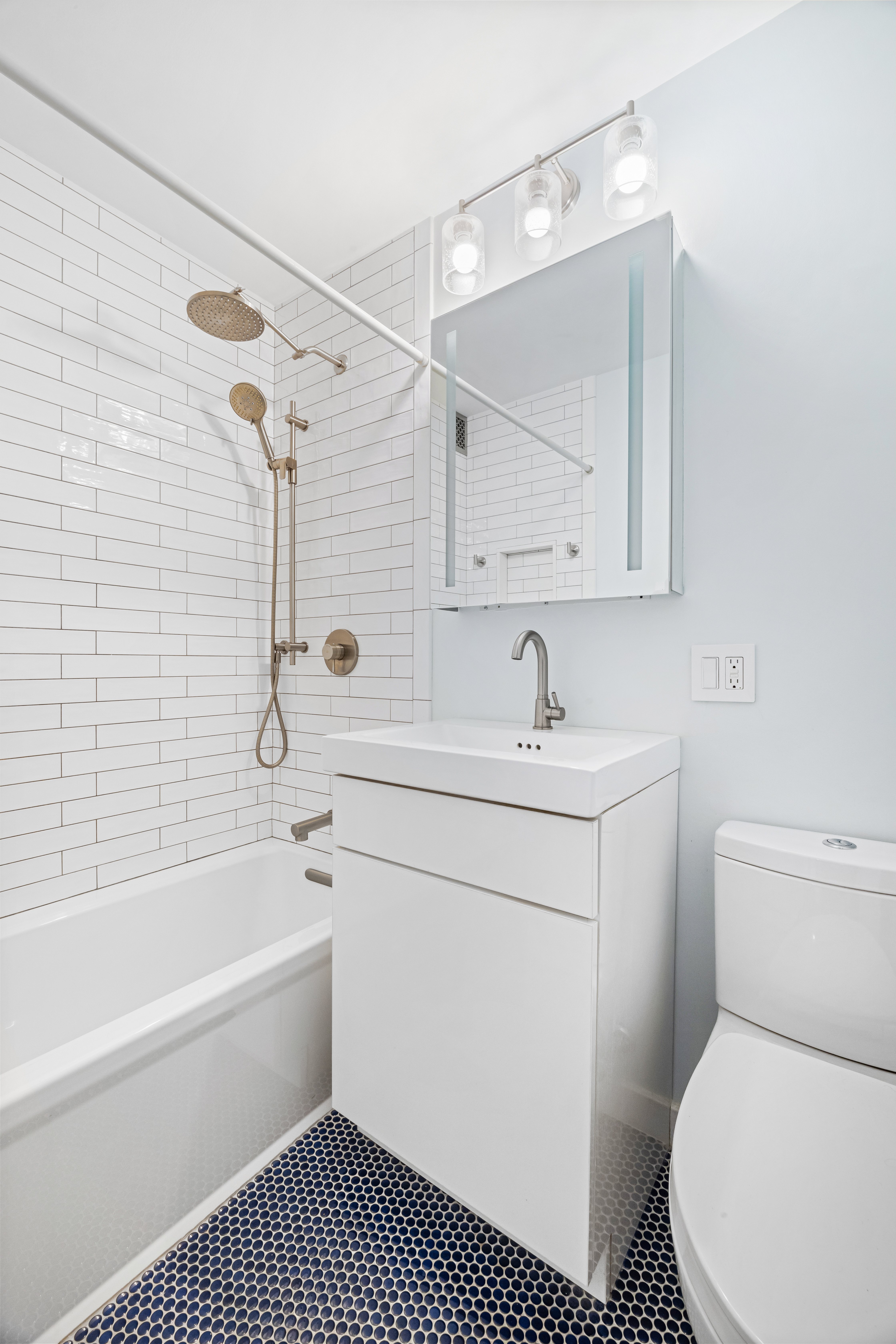 140 7th Avenue, Unit 4J Manhattan, NY 10011 - Photo 7 of 8 a bathroom with a sink toilet and shower
