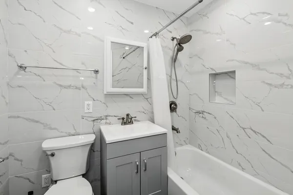 a bathroom with a sink toilet and shower