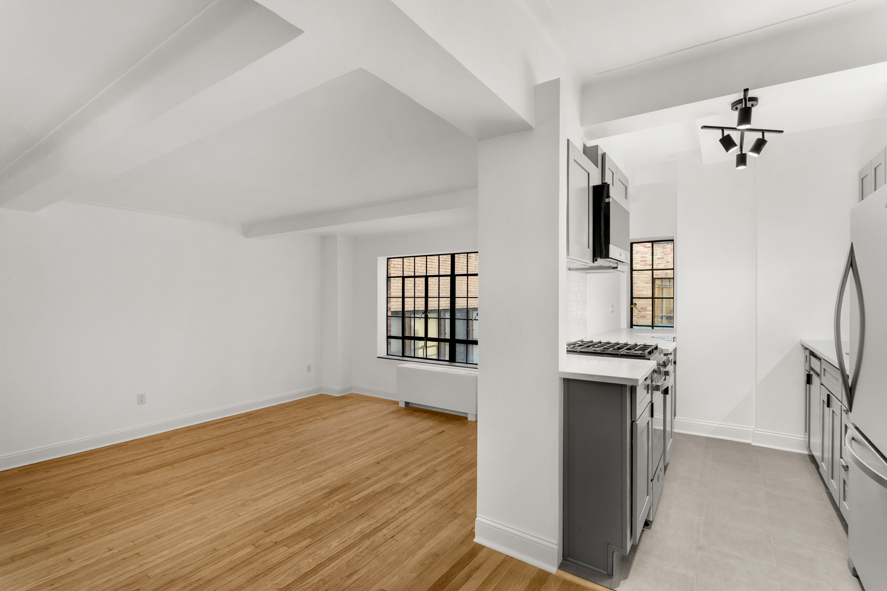 10 Park Avenue, Unit 6A Manhattan, NY 10016 - Photo 7 of 14 wooden floor in an empty room with a window